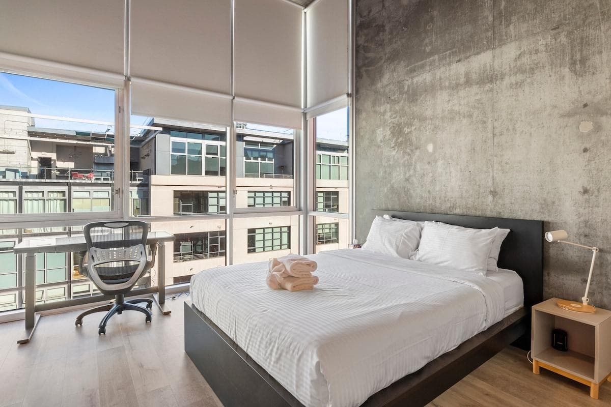 Master bedroom with queen bed, walk-in closet and blackout shades on all windows